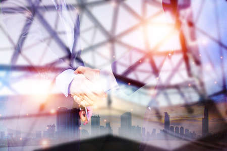 Double exposure picture. Picture mix  building city and businessman is Shake hands show Confident....