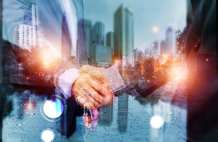 Double exposure picture. Picture mix  building city and businessman is Shake hands show Confident. Picture concept action man and business.の写真素材