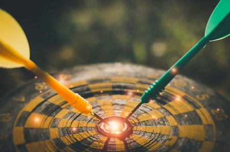 Darts arrows hitting the center of dartboard target, business success conceptの写真素材