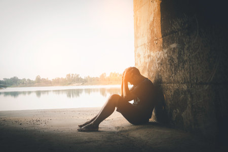 Asia you man sitting alone.He sitting in cave.man very sad and depressed.sad,alone,suicide,despair,sickness,photo health and disappointment concept.の写真素材