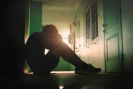 Silhouetted of sad photo. Lonely man sitting on the floor.He is unhappy and sad.He is depression.unlove,unhappy,fail.Photo concept for Disease and depression.の写真素材