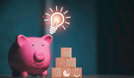 Saving  money.Pig piggy bank with light bulb.The icon finance on wood block. save money.investment,bank,finance,Photo financial saving and Saving.の写真素材
