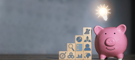 Saving  money.Pig piggy bank with light bulb.The icon finance on wood block. save money.investment,bank,finance,Photo financial saving and Saving.の写真素材