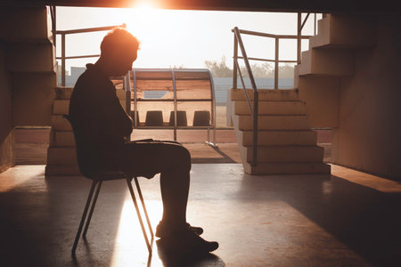 Silhouetted of sad photo. Lonely man sitting on the floor.He is unhappy and sad.He is depression.unlove,unhappy,fail.Photo concept for Disease and depression.の写真素材