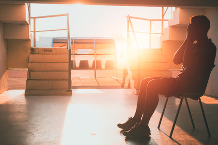 Silhouetted of sad photo. Lonely man sitting on the floor.He is unhappy and sad.He is depression.unlove,unhappy,fail.Photo concept for Disease and depression.の写真素材