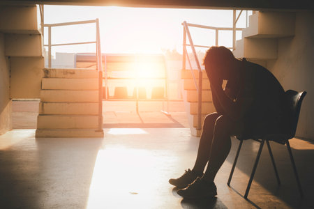 Silhouetted of sad photo. Lonely man sitting on the floor.He is unhappy and sad.He is depression.unlove,unhappy,fail.Photo concept for Disease and depression.の写真素材