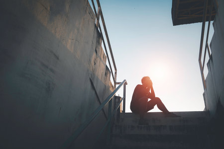 Silhouetted of sad photo. Lonely man sitting on the floor.He is unhappy and sad.He is depression.unlove,unhappy,fail.Photo concept for Disease and depression.の写真素材