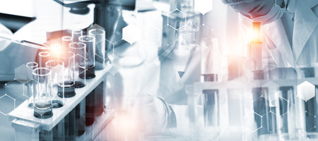 Double exposure of scientific and medical lab equipment and glassware with research and development concept.の写真素材