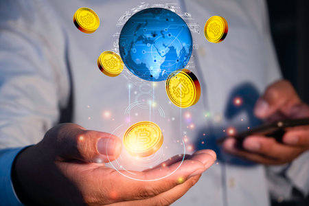 Businessman holding a hologram of bitcoin in his hands. Cryptocurrency concept.の写真素材