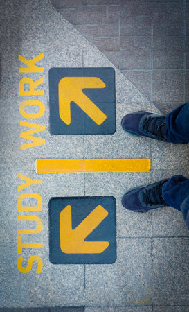 A man standing on âarrowâ word.He is wearing black Shout and standing on Metal floor. go,grow. Photo safe and  sign concept idea.の写真素材