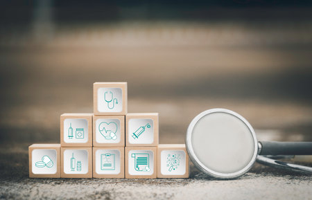 Healthcare and medical icons on wooden cubes with magnifying glass. Healthcare and medical concept.の写真素材
