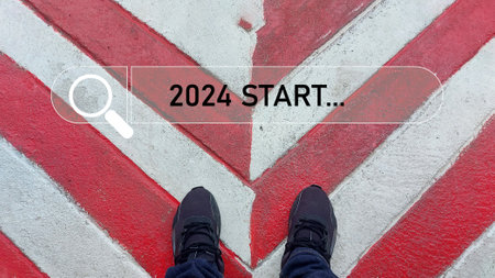 Man's feet on the road with the word 2024 start written on itの写真素材