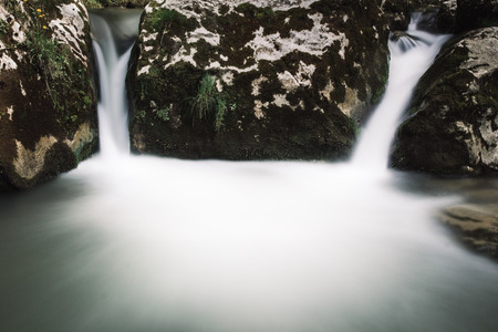 beautiful blue waterfall and river with rocks and plantsの写真素材