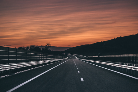 Empty highway with a beautiful sunset in the background