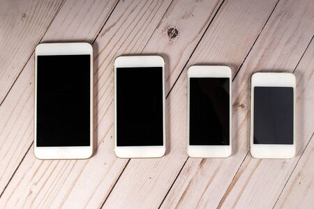 Cellphones on a wooden backgroundの写真素材