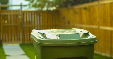 Recycling garbage green basket on a back yardの写真素材