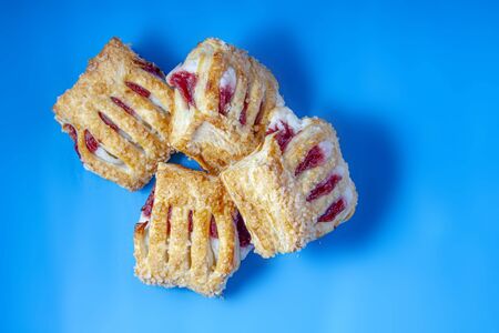 Strawberry Rhubarb Cream Cheese Strudel top view on a blue background