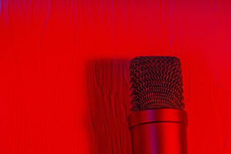 Microphone on lay on a texture background with a red lightの写真素材