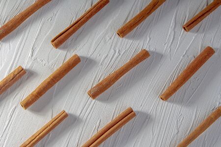 Cinnamon sticks pattern on a texture background