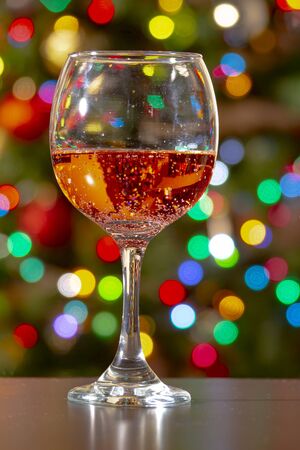 Sweet Fruity Sparkling Rose Wine with bubbles on a wine cup with colourful lightsの写真素材