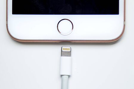 Calgary, Alberta. Canada Dec 12, 2019. Close up of an iPhone Plus and a Lightning to USB Cable.のeditorial素材