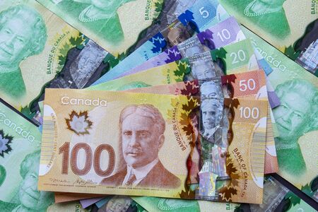 A collage of Canadian bills. Canadian Dollar Suffering from Oil Price Blues. Illustrative.のeditorial素材