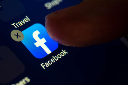 Calgary, Alberta. Canada March 4 2020: A person about to delete the facebook app from the right...
