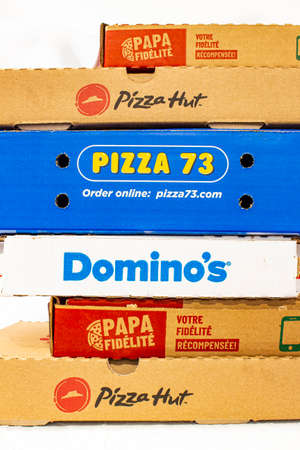 Calgary, Alberta, Canada. March 24 2020. Pizza boxes on top of each other. Pizza hut, Domino's, Papa John's.のeditorial素材