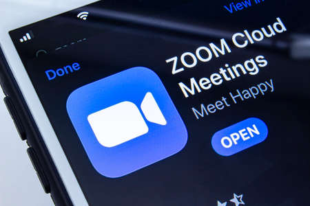 Calgary, Alberta, Canada. April 16, 2020. Downloading the Zoom application.のeditorial素材