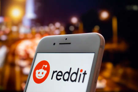 Calgary, Alberta. Canada May 22, 2020. An iPhone Plus with a Reddit logo on the screen.のeditorial素材