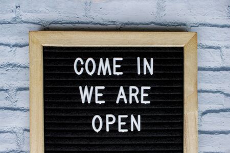 Come in we are open, message on a blackboardの写真素材
