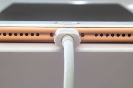 Calgary, Alberta. Canada July 5, 2020. Macro view of an iPhone Plus charging with a lightning USB Cable.のeditorial素材