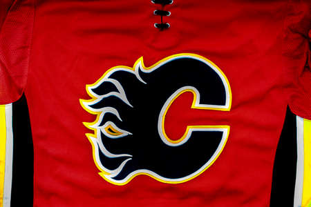 Calgary, Alberta, Canada. July 26 2020. A close up to a Calgary Flames logo on a Red hockey jersey.