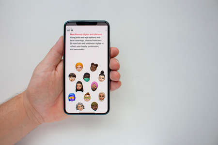 Calgary, Alberta, Canada. Aug 22, 2020. A person holding an iPhone Max Pro with the new Memojis on...