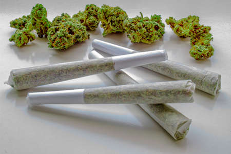 Several Pre-Rolls of Medicinal Cannabis with Flower Cannabis on the backgroundの写真素材