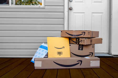 Calgary, Alberta, Canada. Oct 4, 2020. Amazon deliver boxes and envelopes at a home entrance just delivered.のeditorial素材