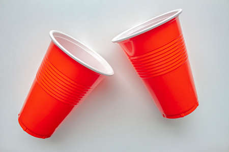 Close up to single use red plastic glass on a white background. Concept: Ban single use plasticの写真素材