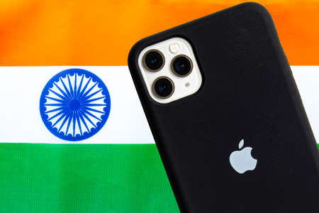 Calgary, Alberta, Canada. Oct 12, 2020. An India flag with an Apple iPhone Pro Max. Concept: Apple manufacturing products in india.のeditorial素材