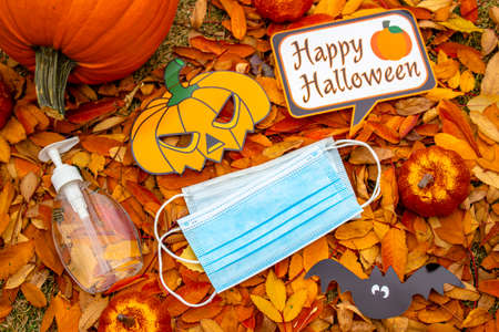 Calgary, Alberta, Canada. Oct 10, 2020. A bottle of a hand sanitazer and facemask with halloween decoration background. Concept: Halloween during a pandemic, covid-19, coronavirus.のeditorial素材