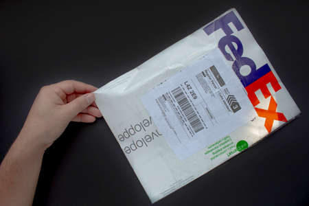 Calgary Alberta, Canada. Oct 17, 2020. A person with a Fedex package. Concept: shipping packages