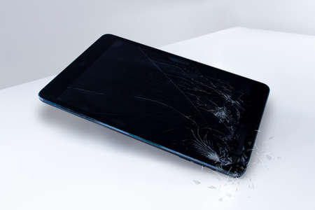 Calgary, Alberta, Canada. Nov. 19, 2020. An iPad with a broken screen on a white surface.のeditorial素材
