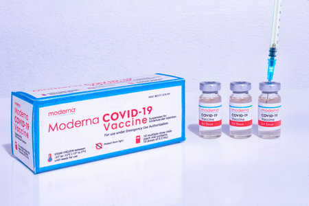 Calgary, Alberta, Canada. Jan 12, 2021. A Moderna box of vials vaccine bottles with an injection Syringes of covid-19 immunization vaccines.のeditorial素材