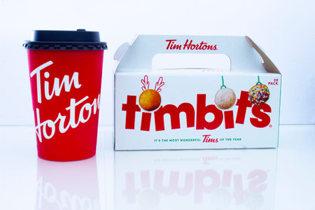 Calgary, Alberta. Canada. Jan 20, 2021. A Tim Hortons coffee with a box of timnits during the holidays.のeditorial素材