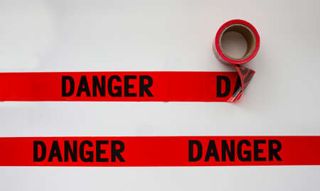 Danger safety barricade tape on whiteの写真素材