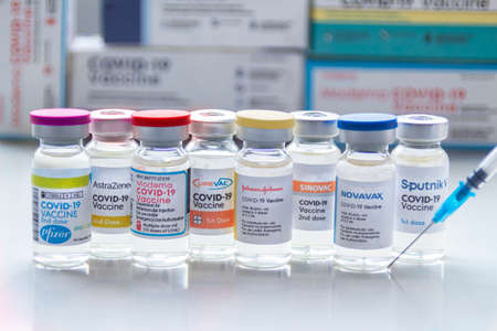 Calgary, Alberta. Canada. Jan 31, 2021. Several covid-19 vaccines brands on vials bottles with a syringe.のeditorial素材