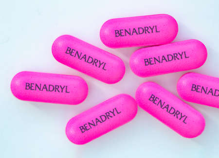 Calgary, Alberta, Canada. Feb 22, 2021. A Macro top view of Benadryl pills on a white background.