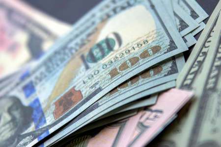 Calgary, Alberta, Canada. March 12, 2021. Several USA currency bills banknotes on black background.