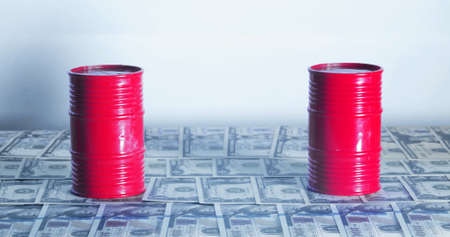 A couple of Barrel of oil. A physical container used to transport crude oil, as most petroleum is moved. On top of American bills.Concept: Oil Pricesの写真素材