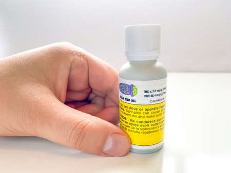 Calgary, Alberta, Canada. Jan 24, 2022. A Person holding a bottle of Mood Ring a high CBD Cannabis...