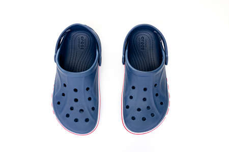 Calgary, Alberta, Canada. Apr 30, 2022. Top view of a couple of blue Crocs Sandals on a white table.